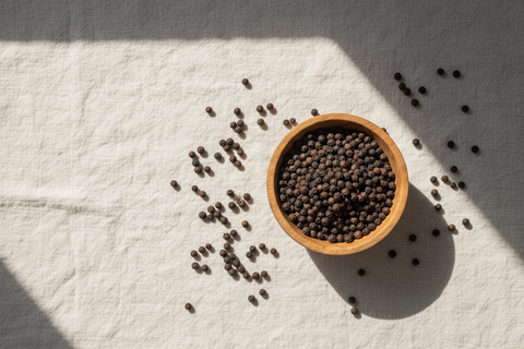 Black Peppercorns — wooden bowl