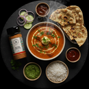 Overhead shot of Butter Chicken shaker with vibrant butter chicken dish